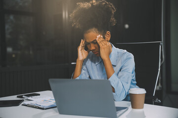 business woman sitting at work stressed , out working hard Feeling stressed out and dizzy from your...