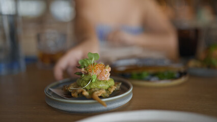 Young hispanic woman eating fusion food at the restaurant