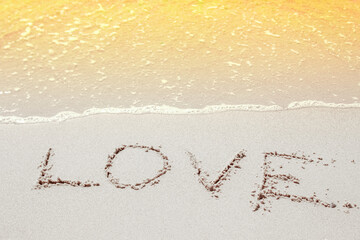 beautiful drawings inscription on the sand of the sea in the summer on the nature