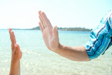 A Hands of a happy parent and child in nature by the sea on a journey background