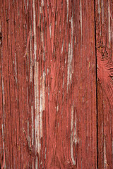 Naklejka premium Detail of old wooden wall covered with falling off red paint