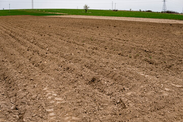Empty plowed field at the beginning of spring season