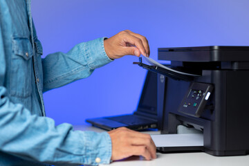 The man using the laser printer.