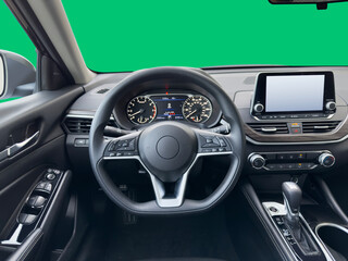 Car dashboard in front of green box