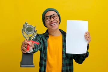 Cheerful Asian student wearing eyeglasses and a casual shirt, holding a piece of paper and a...
