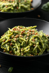 Trofie pasta with creamy spinach sauce and toasted pine nuts