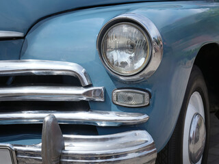 Close-up of the front of a beautiful blue car.
