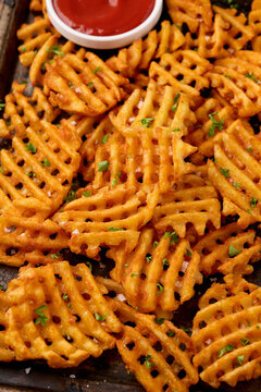 Crisscross potato lattices, golden waffle fries with sea salt and parsley