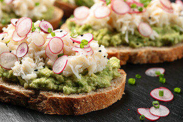 Crab meat and smashed avocado and radishes Sourdough bread toasts