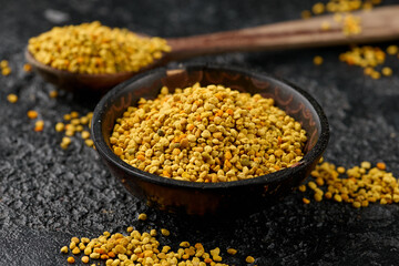 Healthy Honey Bee Pollen grains in wooden bowl.