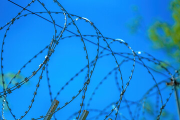 Reinforced barbed steel tape against a clear blue sky