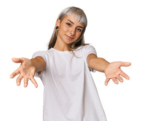 Young caucasian young woman in studio showing a welcome expression.