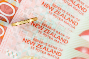 New zealand money, flat lay, 1 dollar coin and 100 dollar banknotes, financial concept