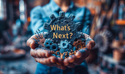 Person holds holographic icon depicting gears and the phrase What's Next? in their hands, representing the concept of innovation, progress, and exploring future possibilities in technology or business