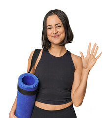 Young Caucasian female athlete with mat smiling cheerful showing number five with fingers.