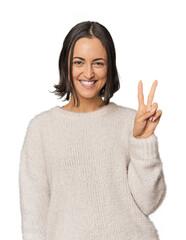 Young Caucasian woman with short hair showing victory sign and smiling broadly.
