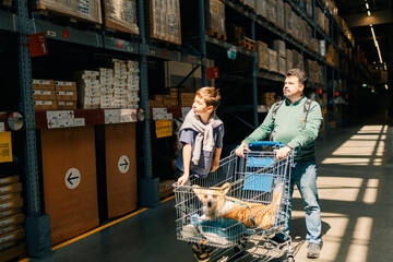 Family time, dad with son and dog in furniture store