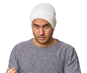 Close-up of a young man in a wool hat, showcasing winter fashion