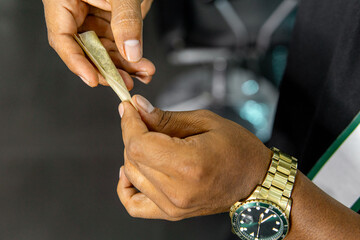 Hands Holding And Preparing A Marijuana Cigar. Mental Health Concept.