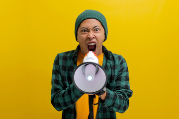 Young Asian man in a beanie hat and casual shirt shouts through a megaphone, expressing annoyance...