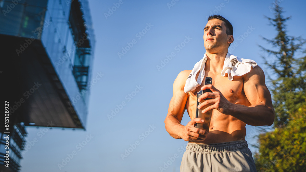 Wall mural one caucasian man young male athlete take a brake during outdoor training in the park outdoor gym ho