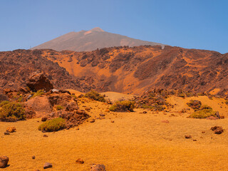 spot in Tenerife with many red rocks and beautiful mountain landscape background