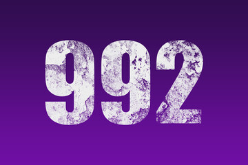 flat white grunge number of 992 on purple background.