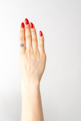Woman's hand with red nail polish. woman hand making four sign on white background
