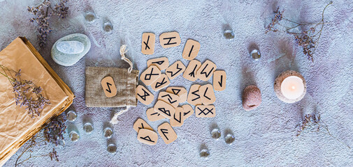 Scandinavian runes for fortune telling made of cardboard and the bag top view web banner