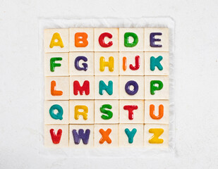 Children Alphabet. Cute Square cookies with colored marmalade filling in the shape of English...