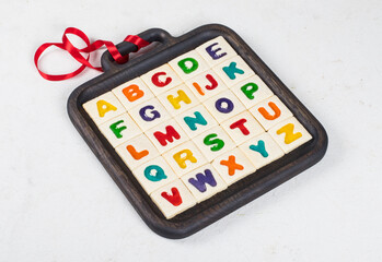 Cookies English Alphabet. Square cookies with colored marmalade filling in the shape of English...