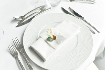 Table setting with cutlery and white napkin