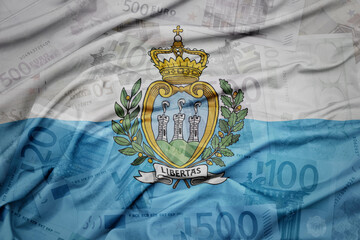 waving colorful national flag of san marino on a euro money banknotes background. finance concept.
