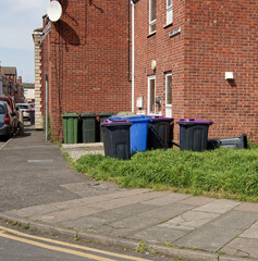 Different colour rubbish bins outside of a house