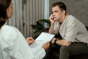 Stressed and depressed patient seeking help from psychiatrist with mental illness and depression in...