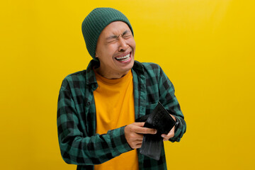 Unemployed Asian man appears bewildered and speechless as he gazes at his empty wallet, facing...