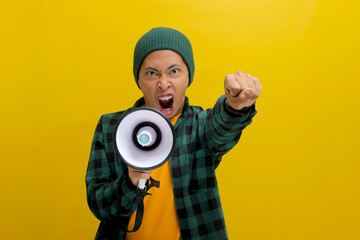 Asian man activist in a beanie hat shouts and yells into a megaphone, demanding change and...