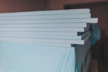 XPS polystyrene insulator boards closeup stacked. Energy efficiency conceptual background. expanded...