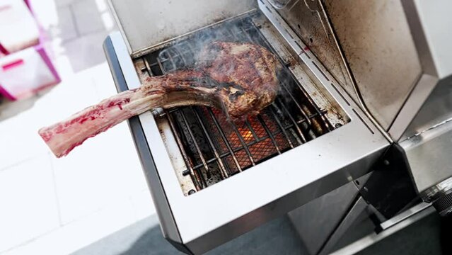 A product of animal origin, most likely beef , sizzles on the grill, emitting enticing flavors. Animal fat is used in the cooking process, and it is soon served as a delicious dish in this kitchen