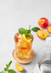 Refreshing peach iced mint tea. The concept of a healthy homemade cold summer drink
