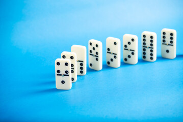 Dominoes with blue background, copy space and various angles.