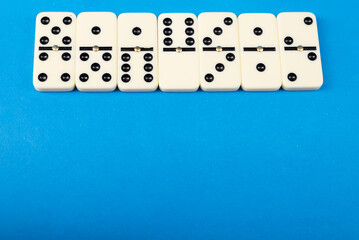 Dominoes with blue background, copy space and various angles.