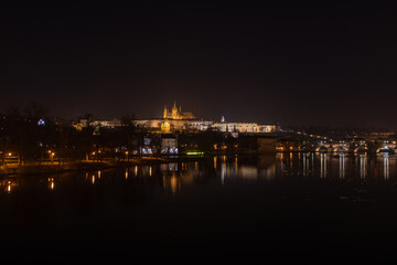 Illuminated Hradcany (Prague Castle)  and Charles Bridge,  St. Vitus Cathedral and St. George church, medieval architecture, Vltava river at night, Bohemia, Czech Republic.