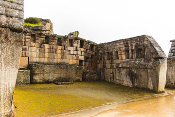 Ancient structures in an inca's city in a cloudy day in Perú
These ruins are slowly falling and the picture shows an inclined wall