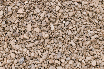 Pebbles background. Top view of river stones shingle , mineral material for pathways in modern...