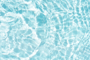 Blue water with ripples on the surface. Defocus blurred transparent blue colored clear calm water surface texture with splashes and bubbles. Water waves with shining pattern texture background.