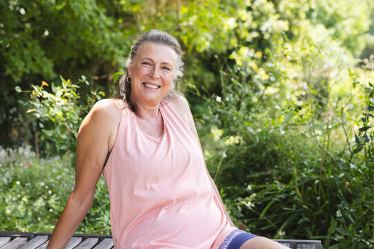 Outdoors, senior Caucasian woman smiling at camera