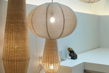 Warm light filters through textured hanging lamps in a serene corner.