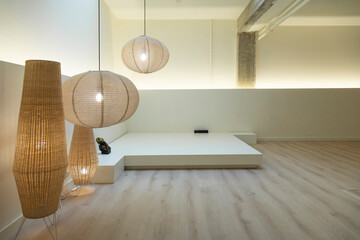 Modern meditation space with natural light and designer lamps.