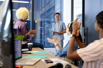 In modern office, diverse young team celebrating, biracial male manager leading - Powered by Adobe